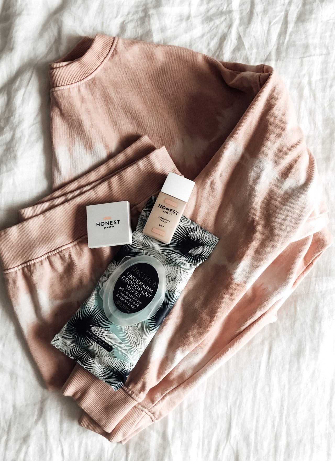 Flat Lay of sweatshirt, deodorant wipes, blush, primer